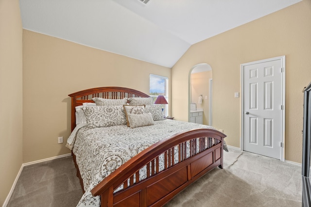 1192 Oak Hill Ln, Murphy, TX 75094 - carpeted bedroom featuring vaulted ceiling, baseboards, arched walkways, and connected bathroom