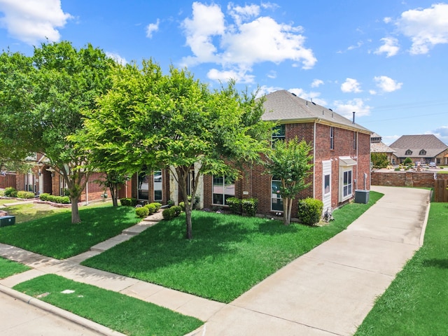 1192 Oak Hill Ln, Murphy, TX 75094 - view of front facade featuring brick siding, a front lawn, and central AC