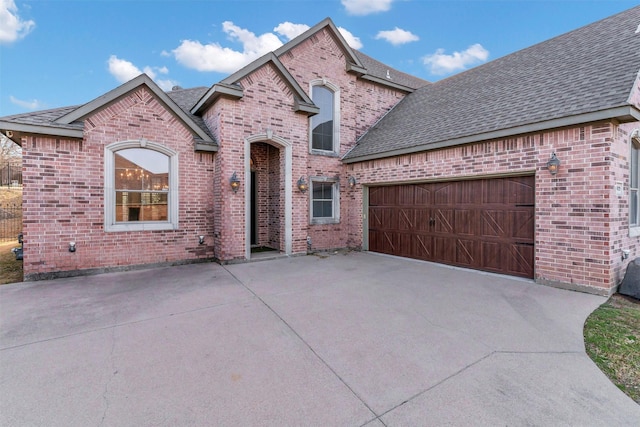 9029 Reata W Dr, Benbrook, TX 76126 - french provincial home with brick siding, roof with shingles, concrete driveway, and an attached garage