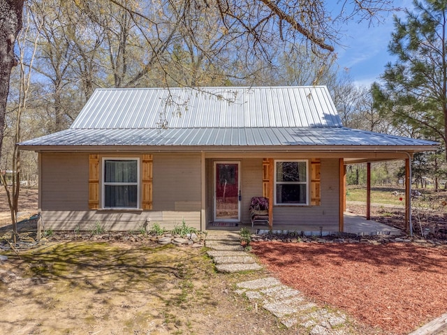 view of front of home with metal roof and a porch