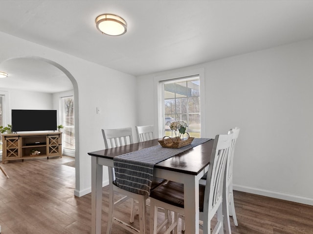 5536 Goodman Ave, Fort Worth, TX 76107 - dining area with arched walkways, wood finished floors, and baseboards
