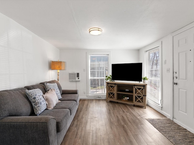 5536 Goodman Ave, Fort Worth, TX 76107 - living room with wood finished floors, baseboards, and an AC wall unit