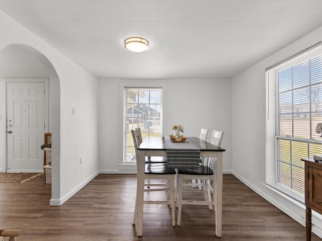 5536 Goodman Ave, Fort Worth, TX 76107 - dining space featuring arched walkways, wood finished floors, and baseboards