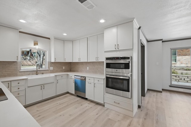 2107 Emerald Lake Dr, Arlington, TX 76013 - unfurnished dining area with crown molding, visible vents, baseboards, light wood-type flooring, and coffered ceiling