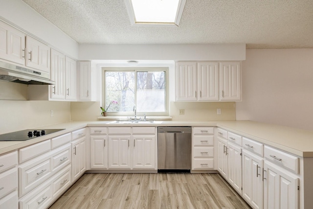 kitchen with light wood-style floors, under cabinet range hood, dishwasher, a sink, and black electric cooktop