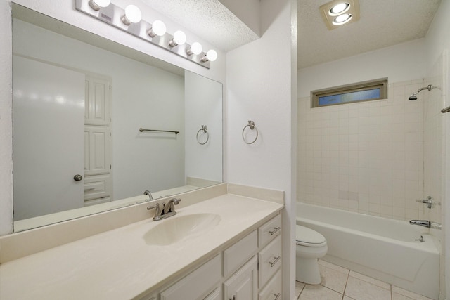 full bath featuring a textured ceiling, vanity, tile patterned flooring, toilet, and washtub / shower combination