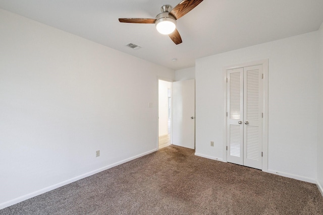 unfurnished bedroom with a closet, carpet flooring, baseboards, and visible vents
