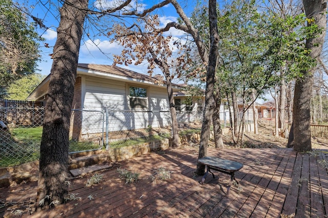 exterior space featuring a wooden deck and fence