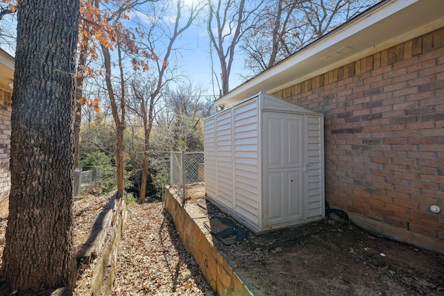 view of shed featuring fence
