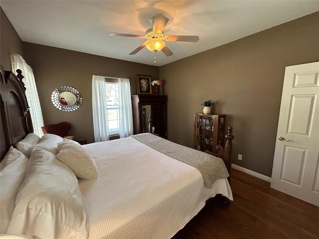 bedroom with ceiling fan, baseboards, and wood finished floors