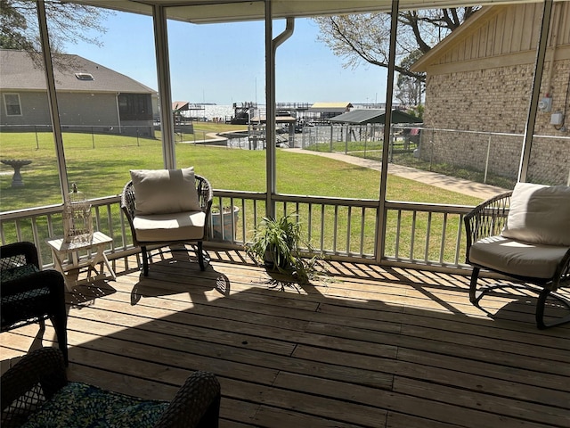 deck with a lawn and a water view