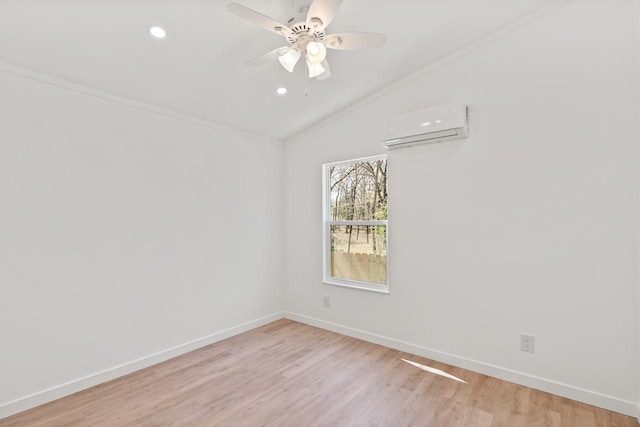 unfurnished room featuring light wood-style floors, baseboards, a wall mounted air conditioner, and ceiling fan