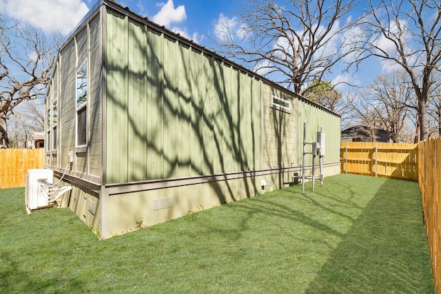 view of side of property featuring a lawn, a fenced backyard, and crawl space