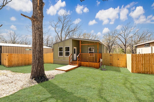 exterior space featuring a front lawn, a gate, and fence