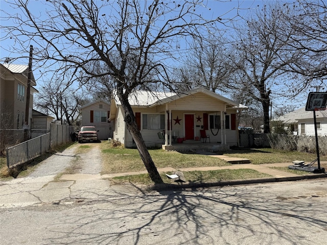 bungalow-style house with fence and driveway