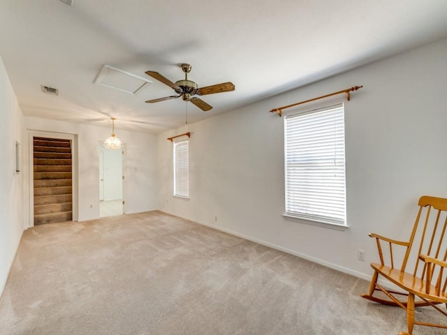 unfurnished bedroom with visible vents, attic access, and carpet flooring