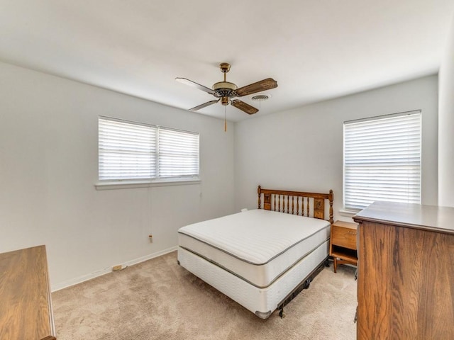 bedroom with baseboards, light colored carpet, and ceiling fan