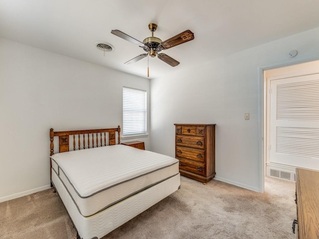 bedroom with light colored carpet, visible vents, and baseboards