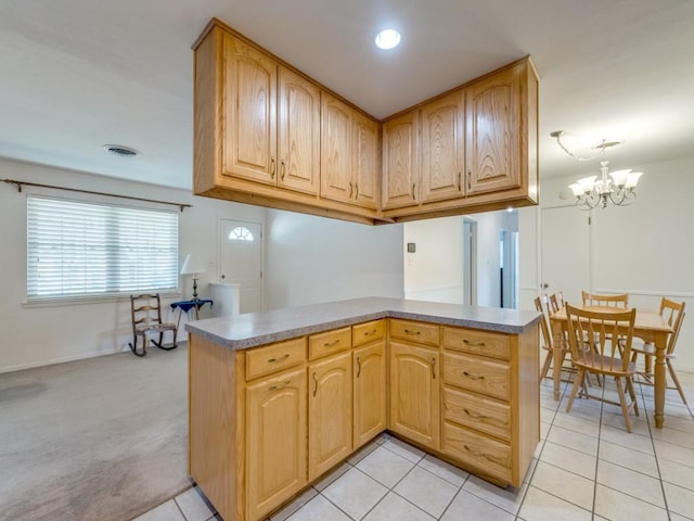 kitchen with visible vents, a notable chandelier, light brown cabinets, light tile patterned flooring, and light colored carpet