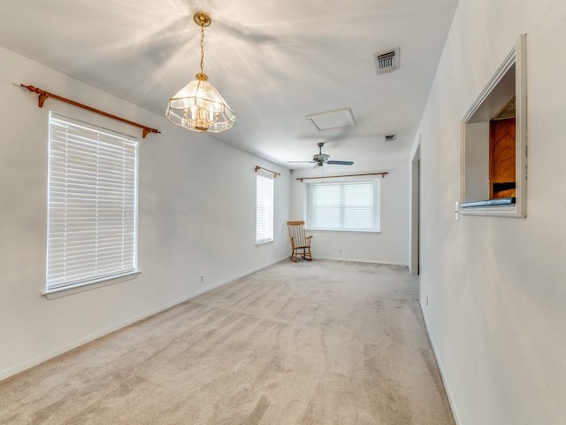 spare room with baseboards, light carpet, visible vents, and attic access