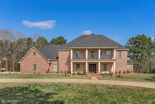 1530 Bellevue Rd, Haughton, LA 71037 - neoclassical / greek revival house featuring a balcony, covered porch, a front lawn, and brick siding