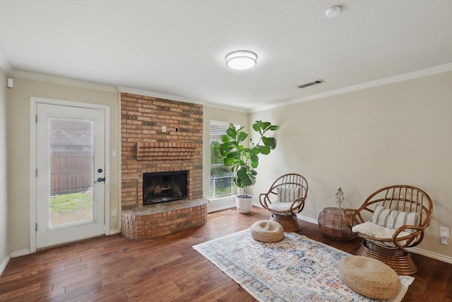 7732 Sagebrush Ct N, North Richland Hills, TX 76182 - living area featuring ornamental molding, wood finished floors, baseboards, and a brick fireplace