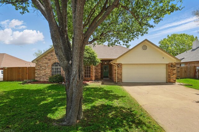 7732 Sagebrush Ct N, North Richland Hills, TX 76182 - view of front of property featuring a garage, brick siding, and driveway