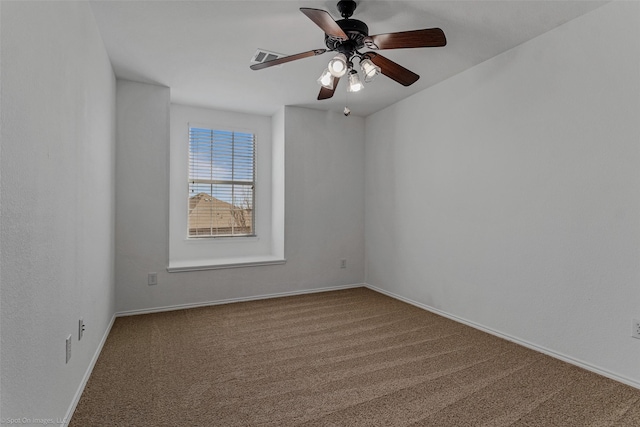 carpeted spare room with baseboards, ceiling fan, and visible vents