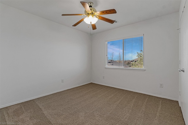 unfurnished room with baseboards, carpet flooring, and a ceiling fan