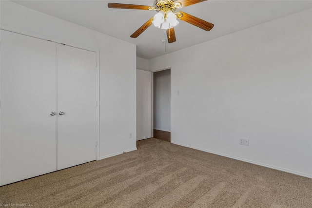 unfurnished bedroom featuring baseboards, a closet, carpet floors, and a ceiling fan