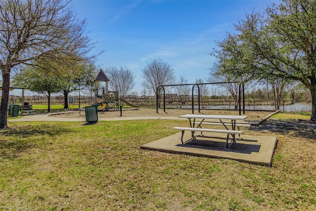 view of property's community with playground community and a yard