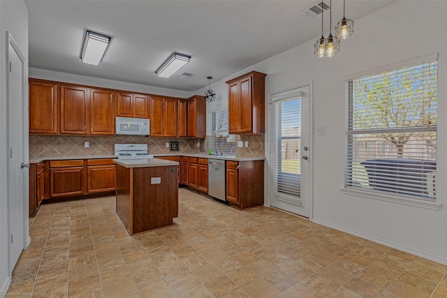 kitchen with light countertops, backsplash, a kitchen island, white appliances, and visible vents