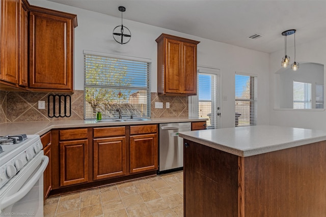 kitchen featuring visible vents, dishwasher, brown cabinets, a sink, and gas range gas stove