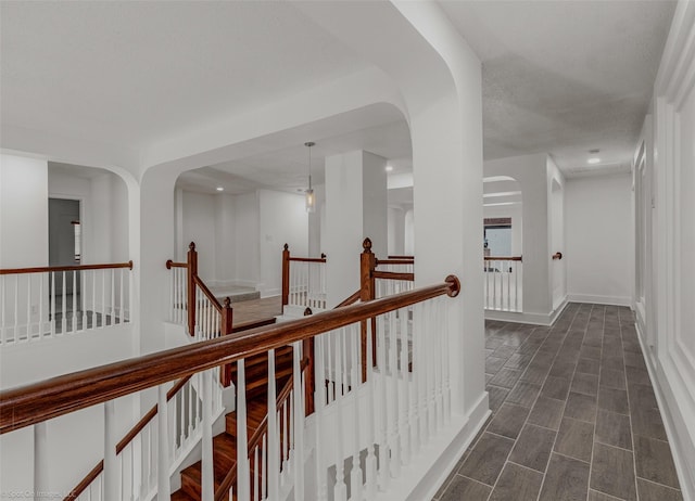 hallway featuring an upstairs landing, baseboards, and recessed lighting
