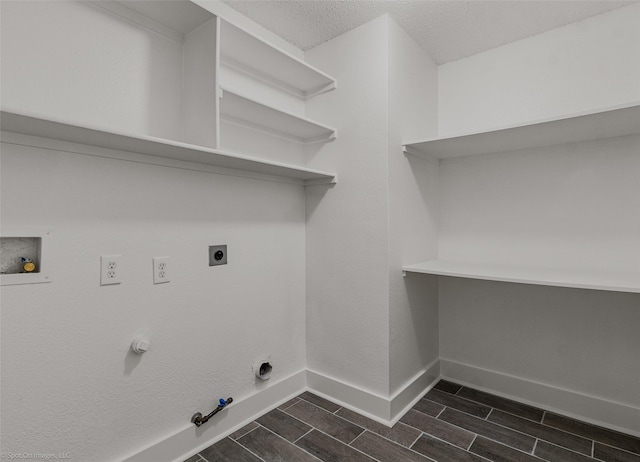 washroom with hookup for an electric dryer, gas dryer hookup, baseboards, laundry area, and wood tiled floor