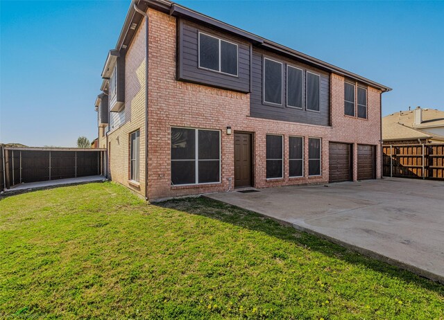 back of house featuring a patio area, brick siding, a fenced backyard, a lawn, and a garage