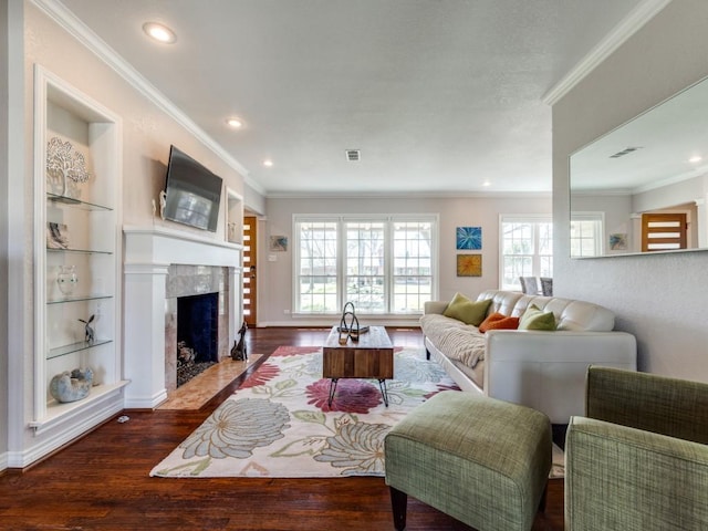 1410 Corto Dr, Dallas, TX 75218 - living room with dark wood finished floors, ornamental molding, built in shelves, a fireplace, and recessed lighting
