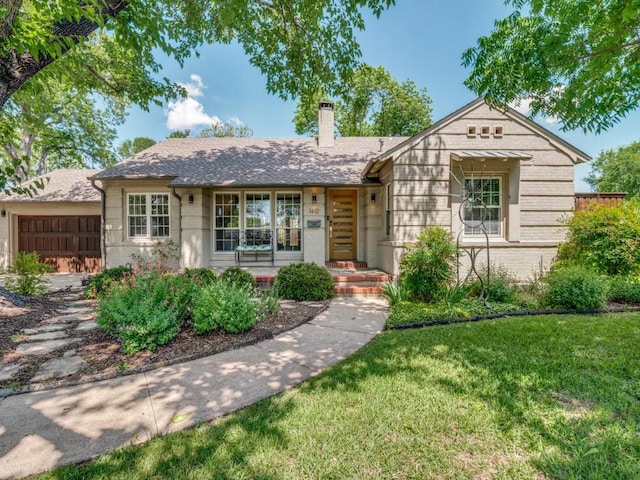1410 Corto Dr, Dallas, TX 75218 - view of front of property featuring a chimney, a front lawn, and brick siding