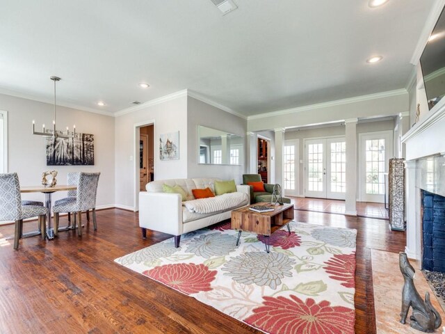 1410 Corto Dr, Dallas, TX 75218 - living room with wood finished floors, a chandelier, recessed lighting, ornamental molding, and baseboards