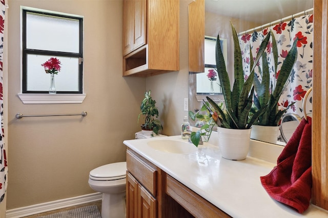 2718 Typhon Dr, Grand Prairie, TX 75052 - full bathroom with baseboards, vanity, curtained shower, and toilet