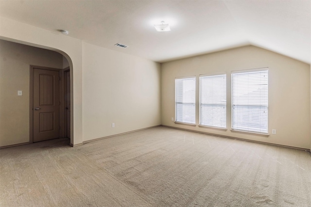 1209 Kachina Ln, Fort Worth, TX 76052 - empty room with arched walkways, light colored carpet, vaulted ceiling, baseboards, and a smoke detector