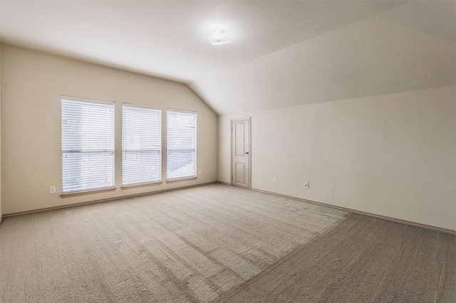 1209 Kachina Ln, Fort Worth, TX 76052 - additional living space with vaulted ceiling, light colored carpet, and baseboards