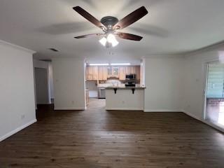 6904 Glenwood Dr, North Richland Hills, TX 76182 - unfurnished living room featuring dark wood-style floors, ceiling fan, baseboards, and ornamental molding
