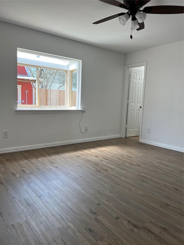 6904 Glenwood Dr, North Richland Hills, TX 76182 - empty room with dark wood-style flooring, a ceiling fan, and baseboards