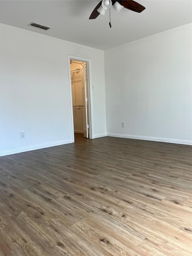 6904 Glenwood Dr, North Richland Hills, TX 76182 - empty room with a ceiling fan, dark wood-style floors, and baseboards