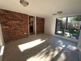 6904 Glenwood Dr, North Richland Hills, TX 76182 - unfurnished living room with brick wall