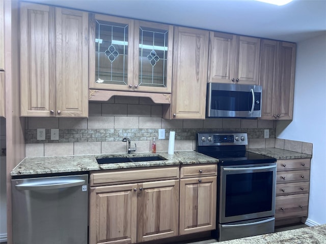 6904 Glenwood Dr, North Richland Hills, TX 76182 - kitchen featuring stainless steel appliances, a sink, backsplash, light stone countertops, and glass insert cabinets