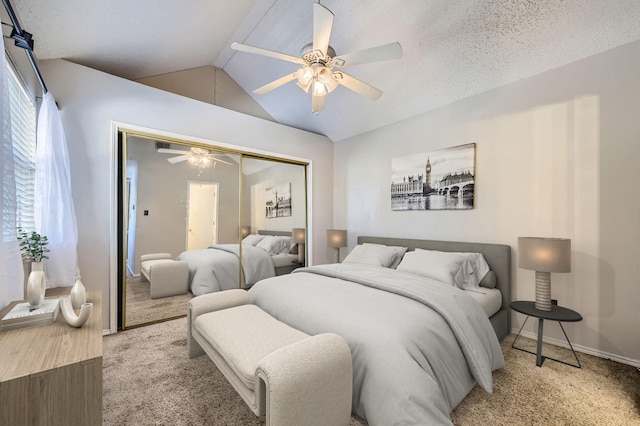 bedroom with baseboards, a closet, vaulted ceiling, carpet, and a ceiling fan