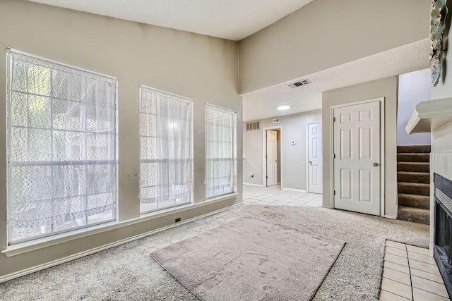 interior space with visible vents, a healthy amount of sunlight, and carpet floors