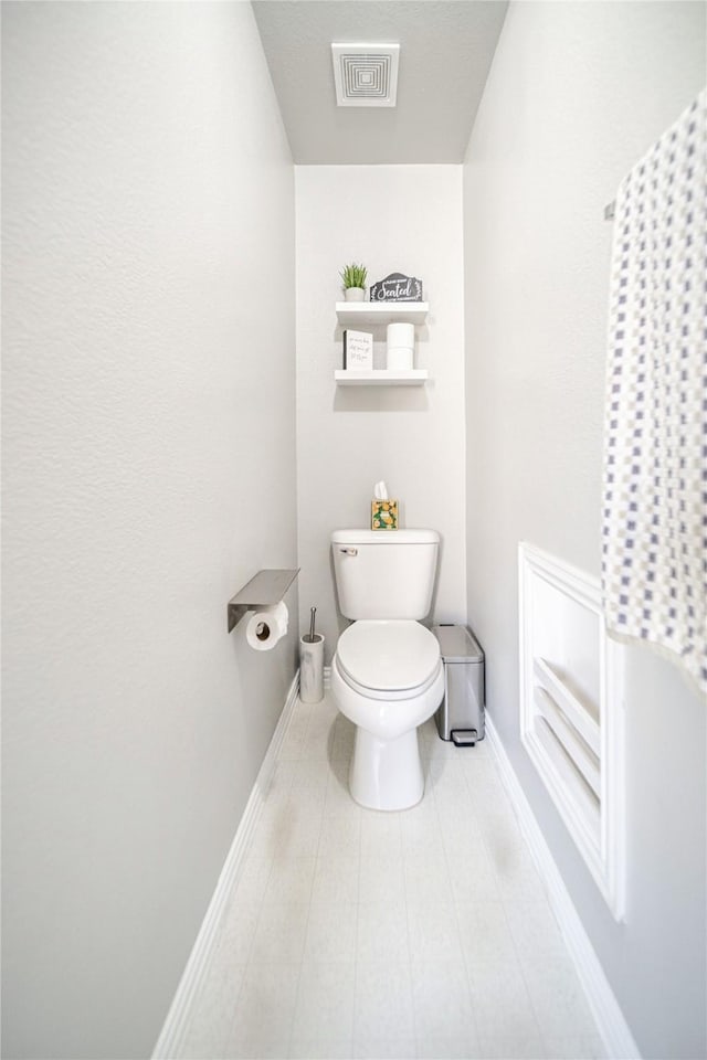 bathroom with visible vents, toilet, and baseboards